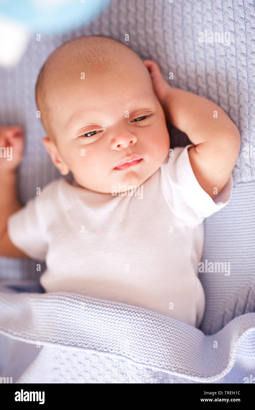Sleepy baby boy lying in bed closeup. Bed time. Childhood. Stock Photo