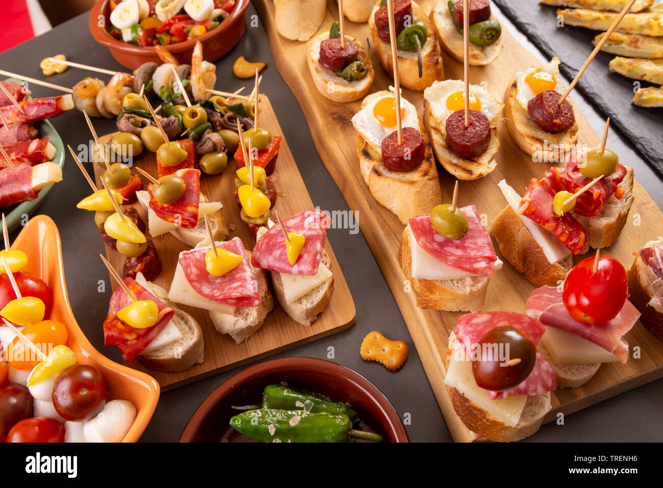 Small appetizers on skewer with cheese, olives and sausage. Spanish