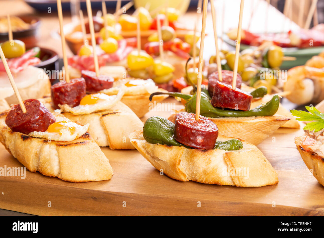 Small appetizers on skewer with cheese, olives and sausage. Spanish