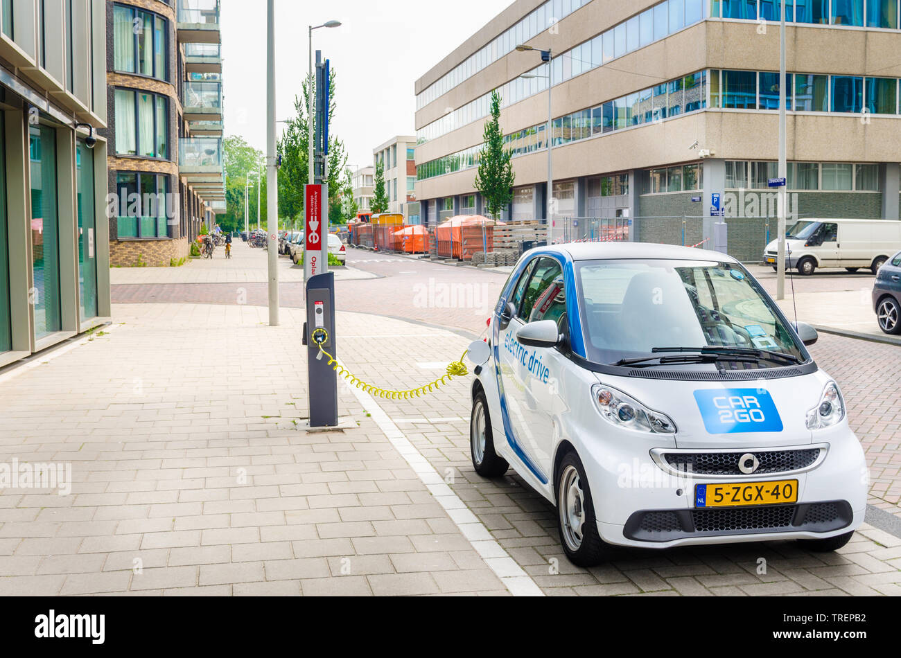 Amsterdam, The Netherlands - June 12, 2016: Car2Go Electric Car being Charged. Car2go is carsharing service available in Europe and North America. Stock Photo