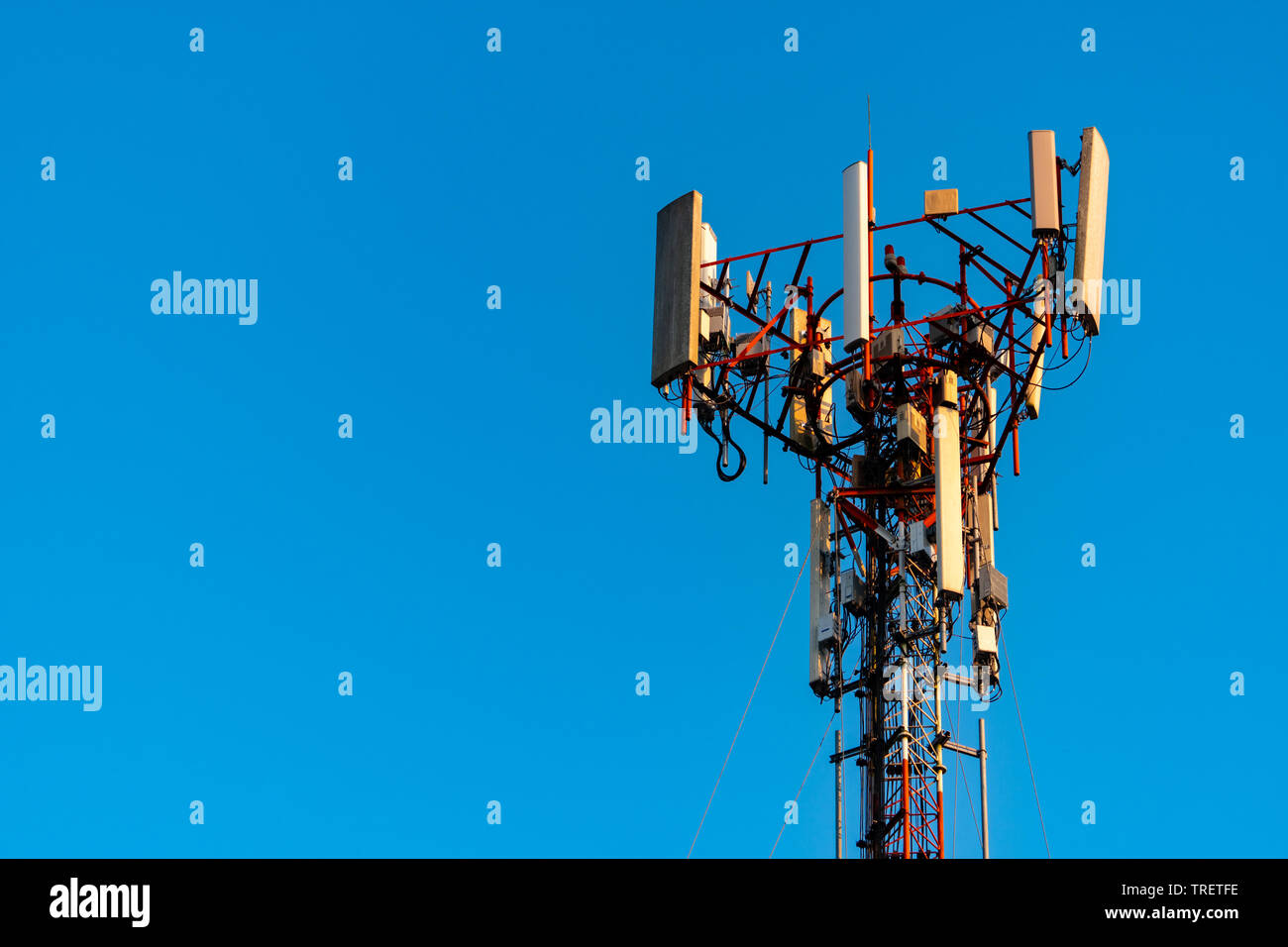 Telecommunication tower with clear blue sky background. Antenna on blue sky background. Radio and satellite pole. Communication technology. Stock Photo