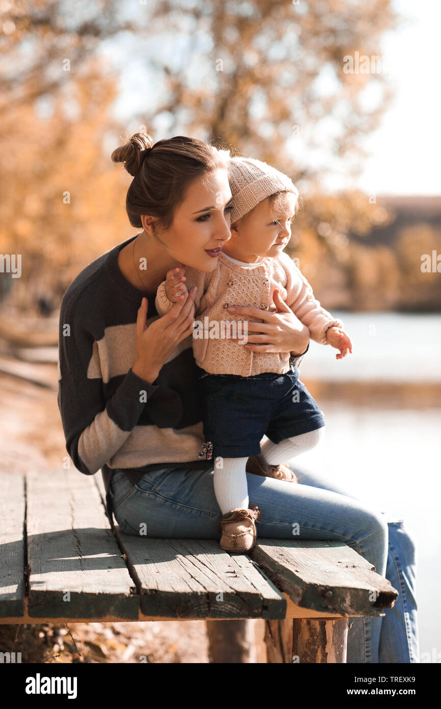 Young Woman Holding Baby Girl 1 Year Old Wearing Knitted Clothes Posing Outdoors Parenthood Stock Photo Alamy Young Woman Holding Baby Girl 1 Year Old Wearing Knitted Clothes Posing Outdoors Parenthood Stock Photo Alamy