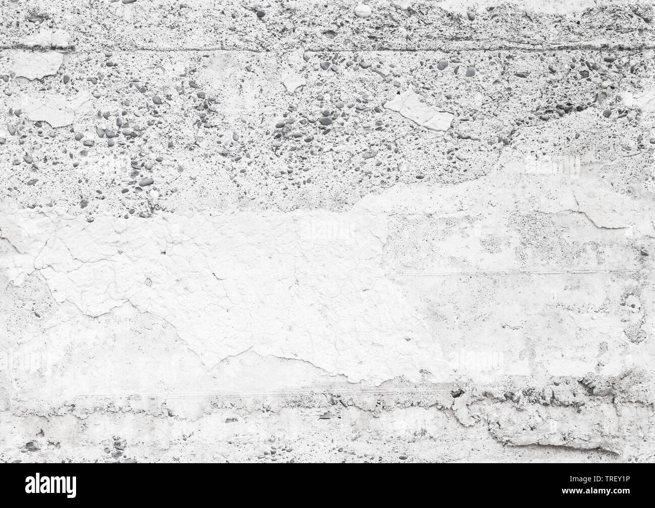 Seamless background photo texture of an old white concrete wall with faded stucco layer and small gray stones Stock Photo