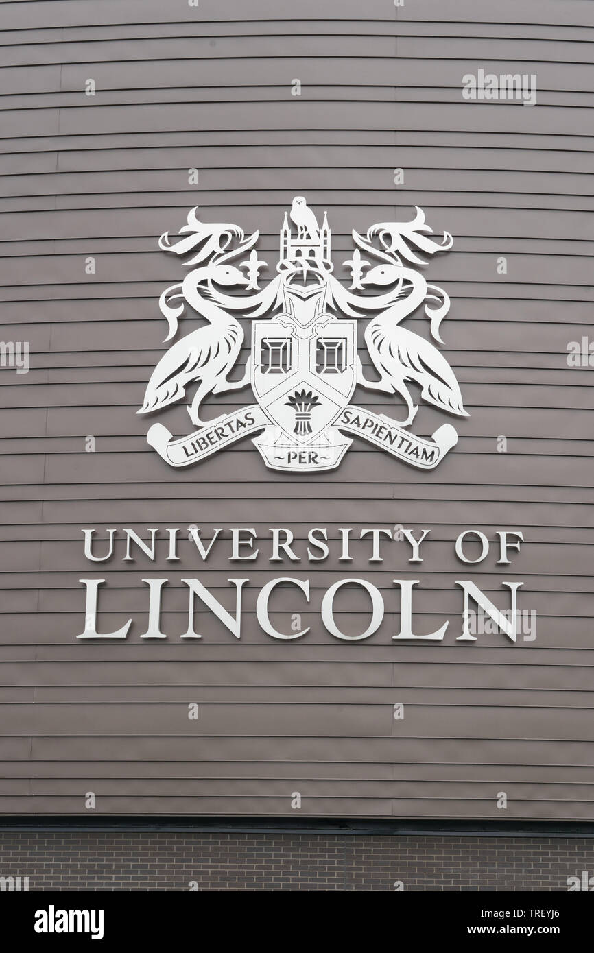 The emblem and motto on the sign board for the University of Lincoln in England UK Stock Photo