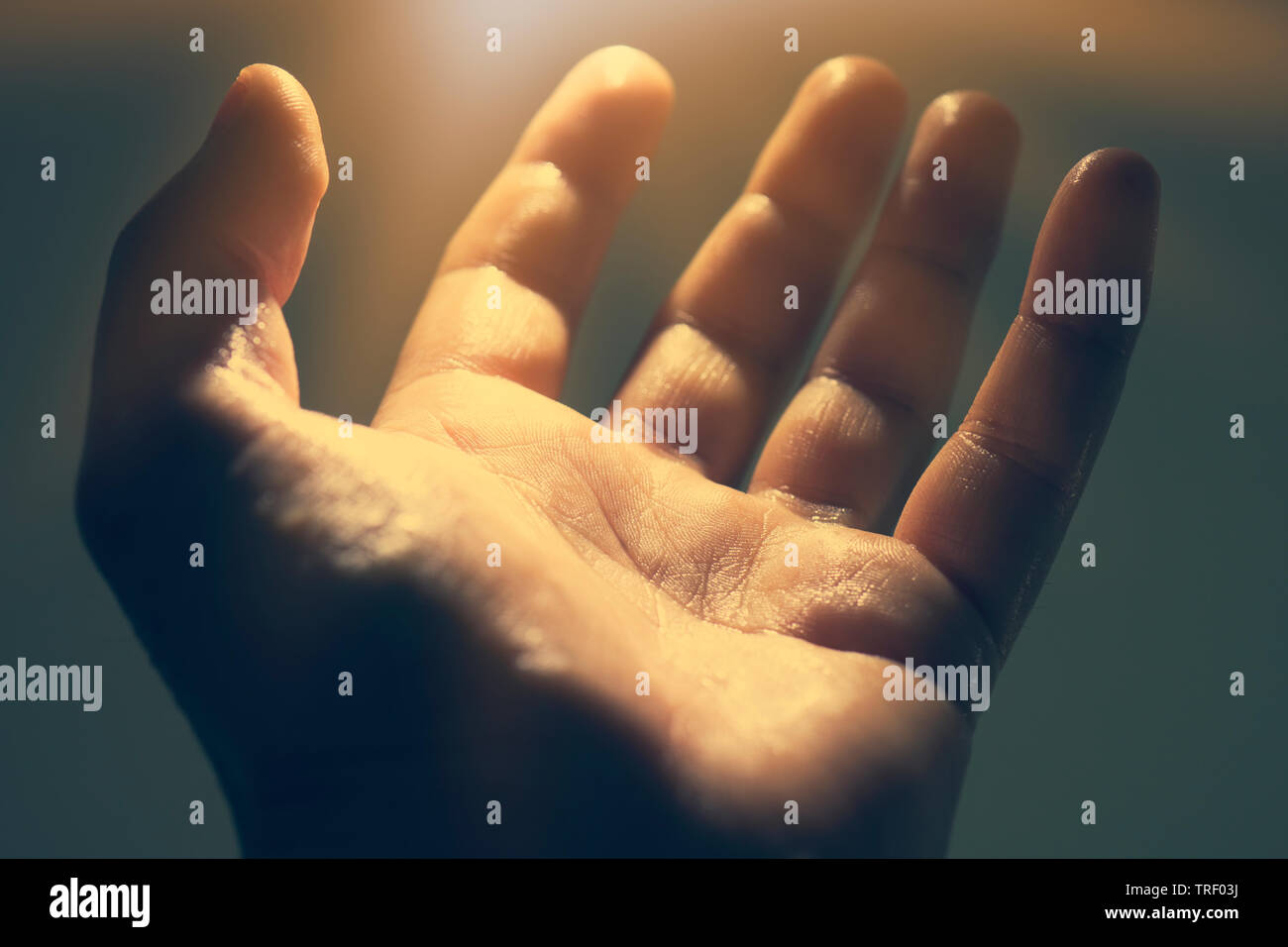 Light in human hand in the dark, miracle concept Stock Photo