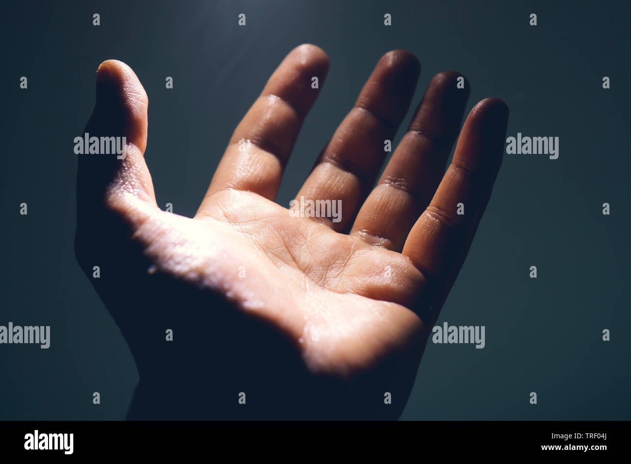 Light in human hand in the dark, miracle concept Stock Photo