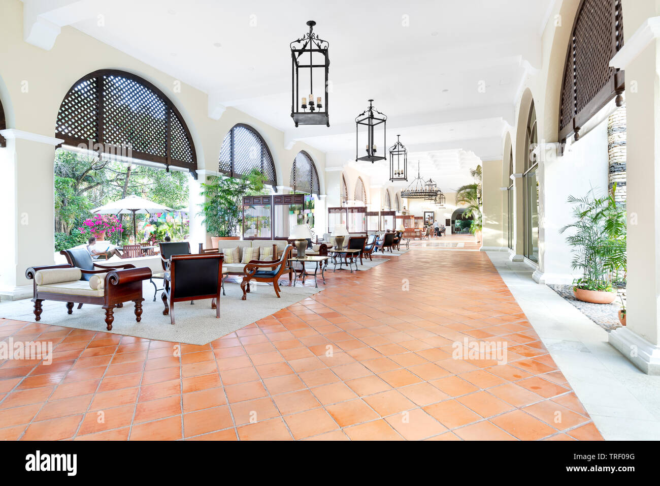 The beautiful outside lobby area of the Valentin Imperial Maya resort that features plenty of seating to relax and a bar at the end to enjoy. Stock Photo