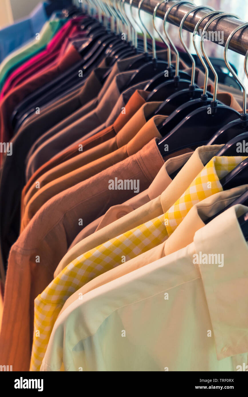 Vintage style image of male mens shirts on hangers in a shop display or  wardrobe closet rail Stock Photo - Alamy