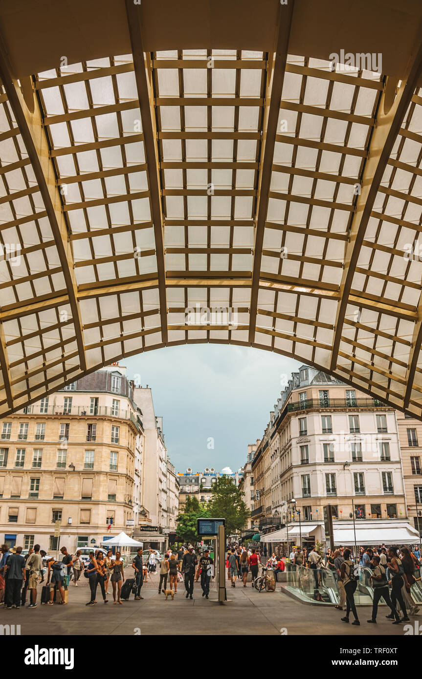 Ceiling structure and people at the entrance of shopping center in Paris. One of the most