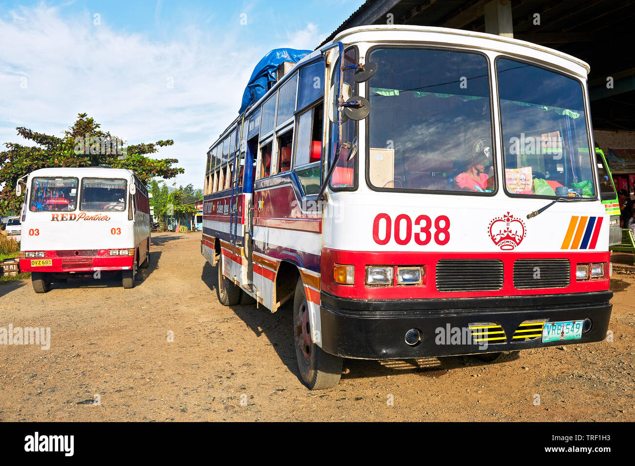 Puerto Princesa City, Palawan, Philippines: Front view of two old overland buses waiting for passengers at the bus terminal Stock Photo