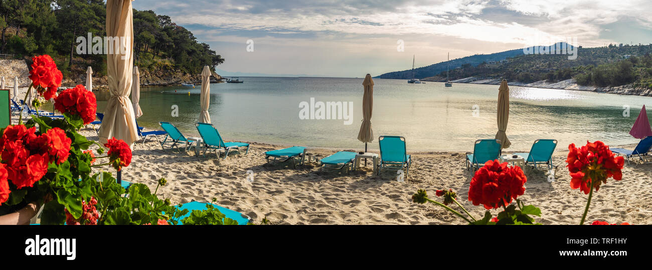 Landscape with sun umbrella and lounge chair on Aliki beach at Thassos islands, Greece Stock Photo