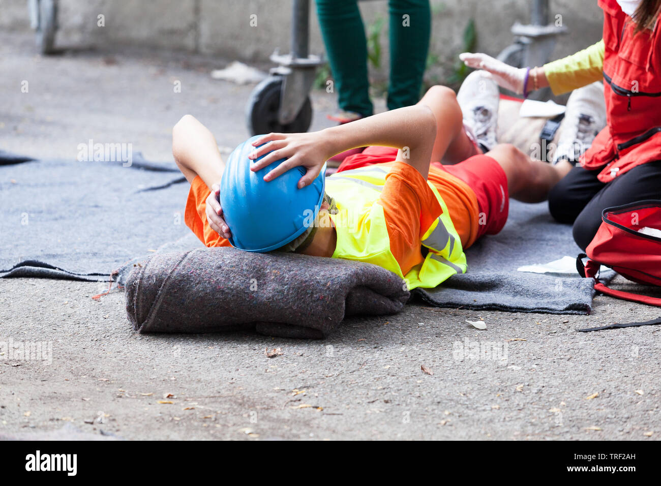 First aid after work accident, injured worker on a construction site Stock Photo