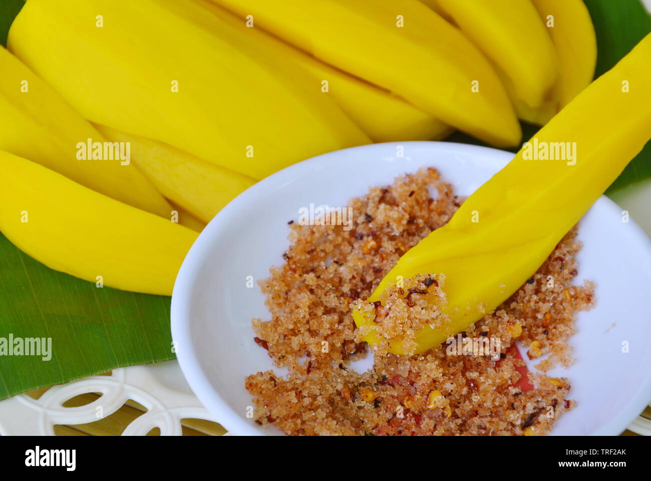 pickled mango sweet and sour taste dipping with salt pepper Stock Photo