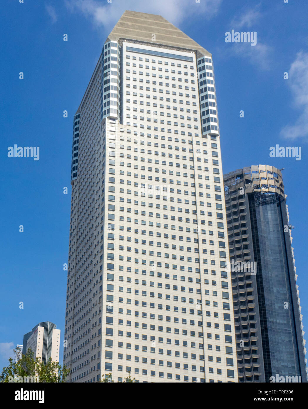 Skyscraper Millenia Tower designed by Eamonn Kevin Roche architect at Marina Centre Singapore. Stock Photo