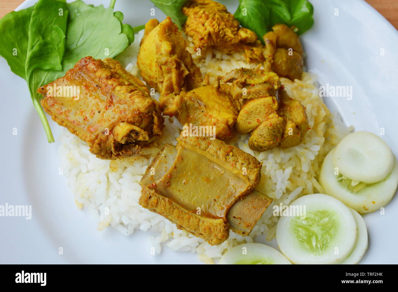 pork rib and chicken in yellow curry on plain rice Stock Photo Alamy
