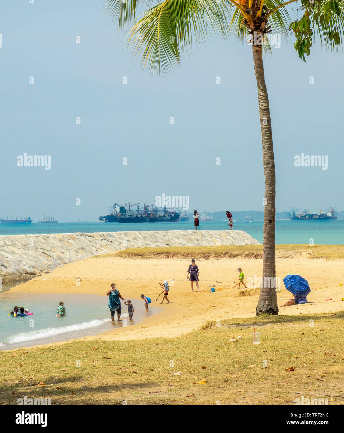 People playing and going to the beach at East Coast Park Singapore on a sunny day. Stock Photo