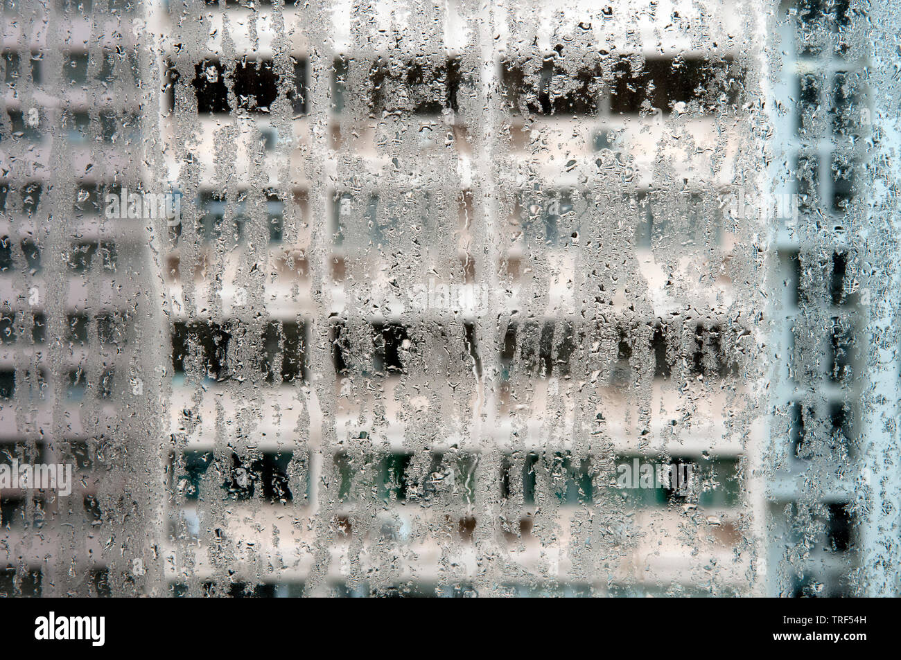 Hong Kong Tower Blocks Viewed Through A Window Running With Condensation Stock Photo