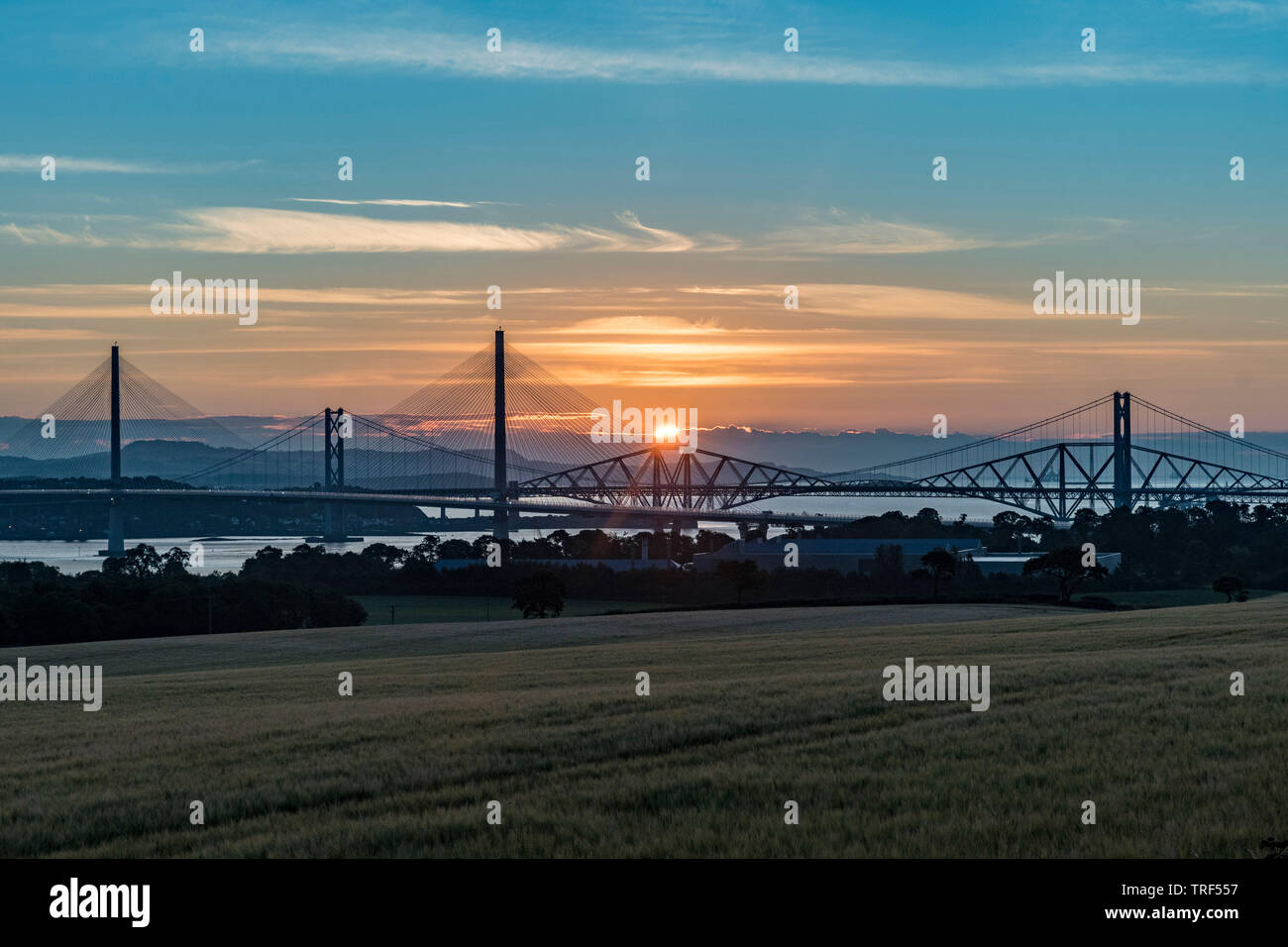 Sunrise with the three Forth Bridges at South Queensferry Stock Photo