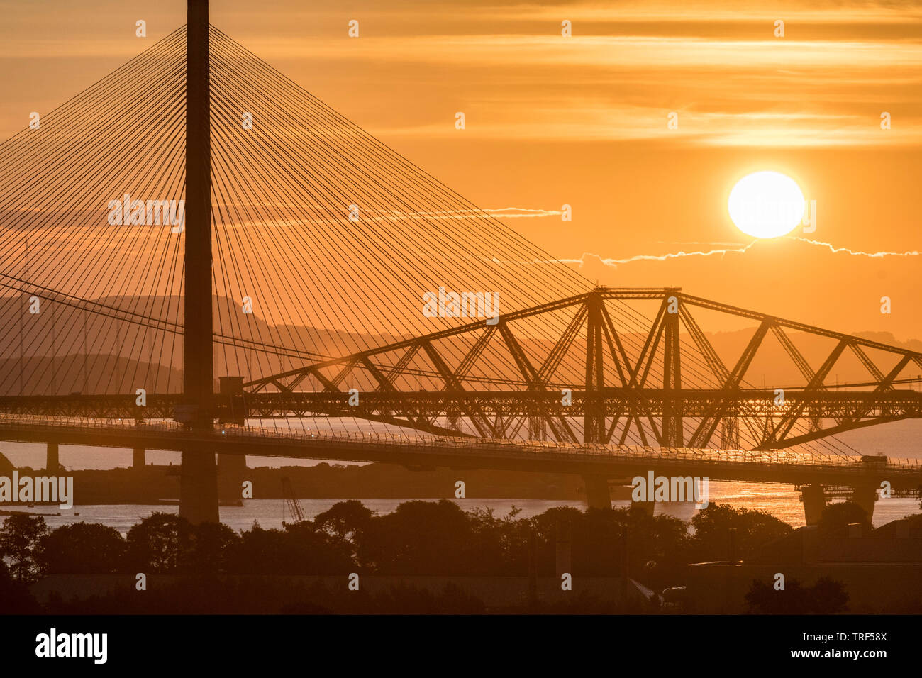 Sunrise with the three Forth Bridges at South Queensferry Stock Photo