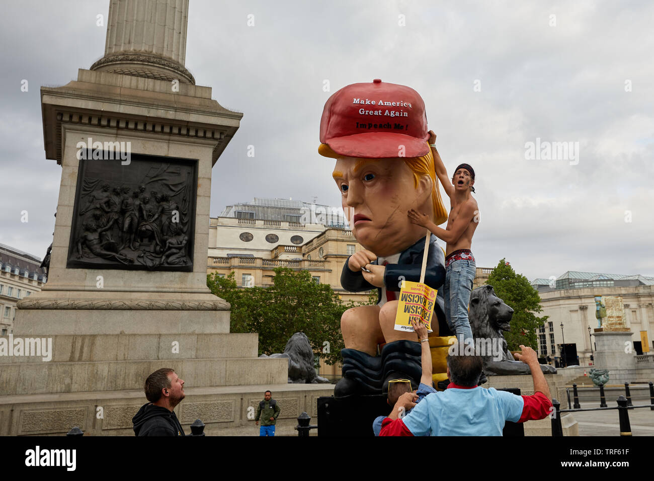 London, UK. - 4 June 2019: A large figure mocking US President Trump being moved into position on a day of protests against his visit. Stock Photo