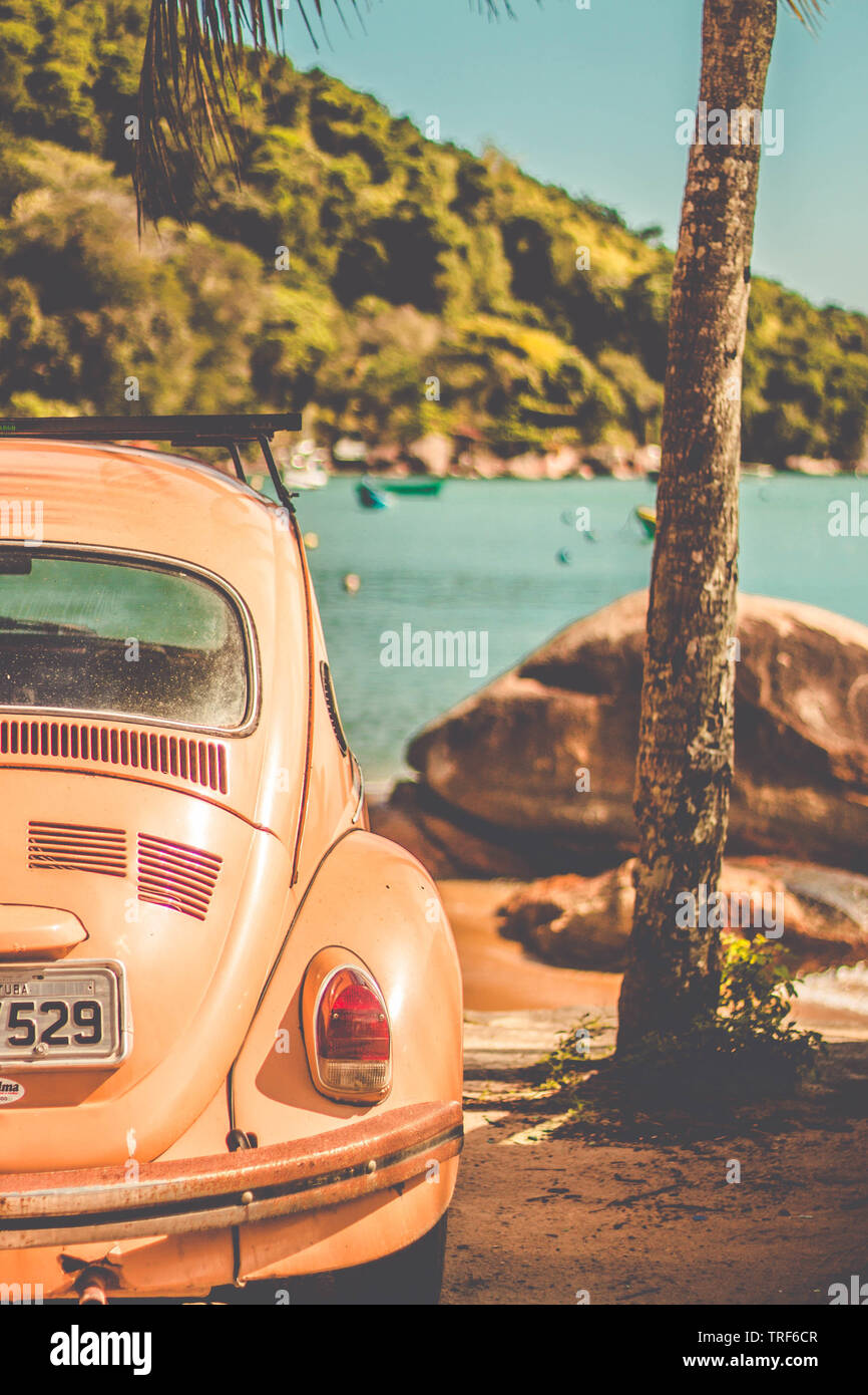 UBATUBA/SAO PAULO/BRAZIL - 09.09.2018: Volkswagen Beetle parking at the seaside. Car in front of the ocean landscape Stock Photo
