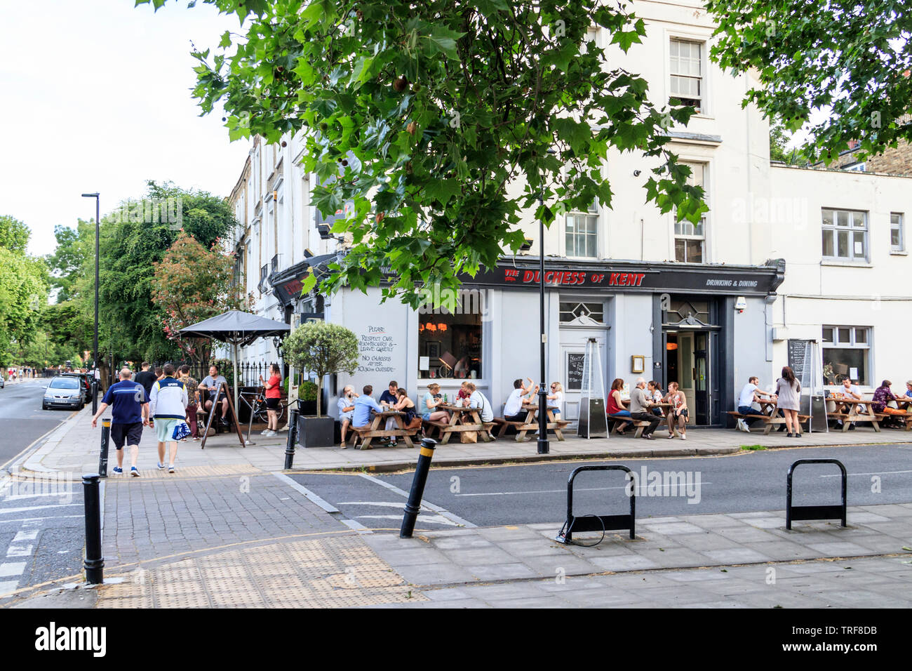 Drinkers outside the Duchess of Kent Pub on the corner of Ellington Street and Liverpool Road, London, UK, on a warm June evening Stock Photo