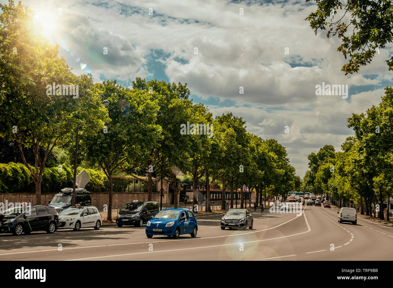 Cars on a tree-lined street in sunny day at Paris. One of the most  impressive world's cultural center in France Stock Photo - Alamy