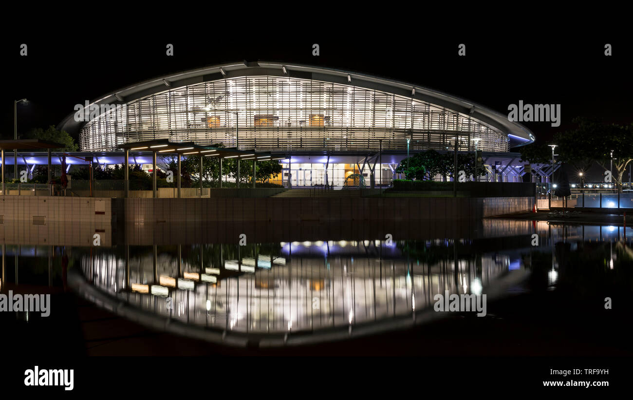 The Darwin Convention Center is reflected in the waters in front of it, illuminated by the evening lights, Australia Stock Photo