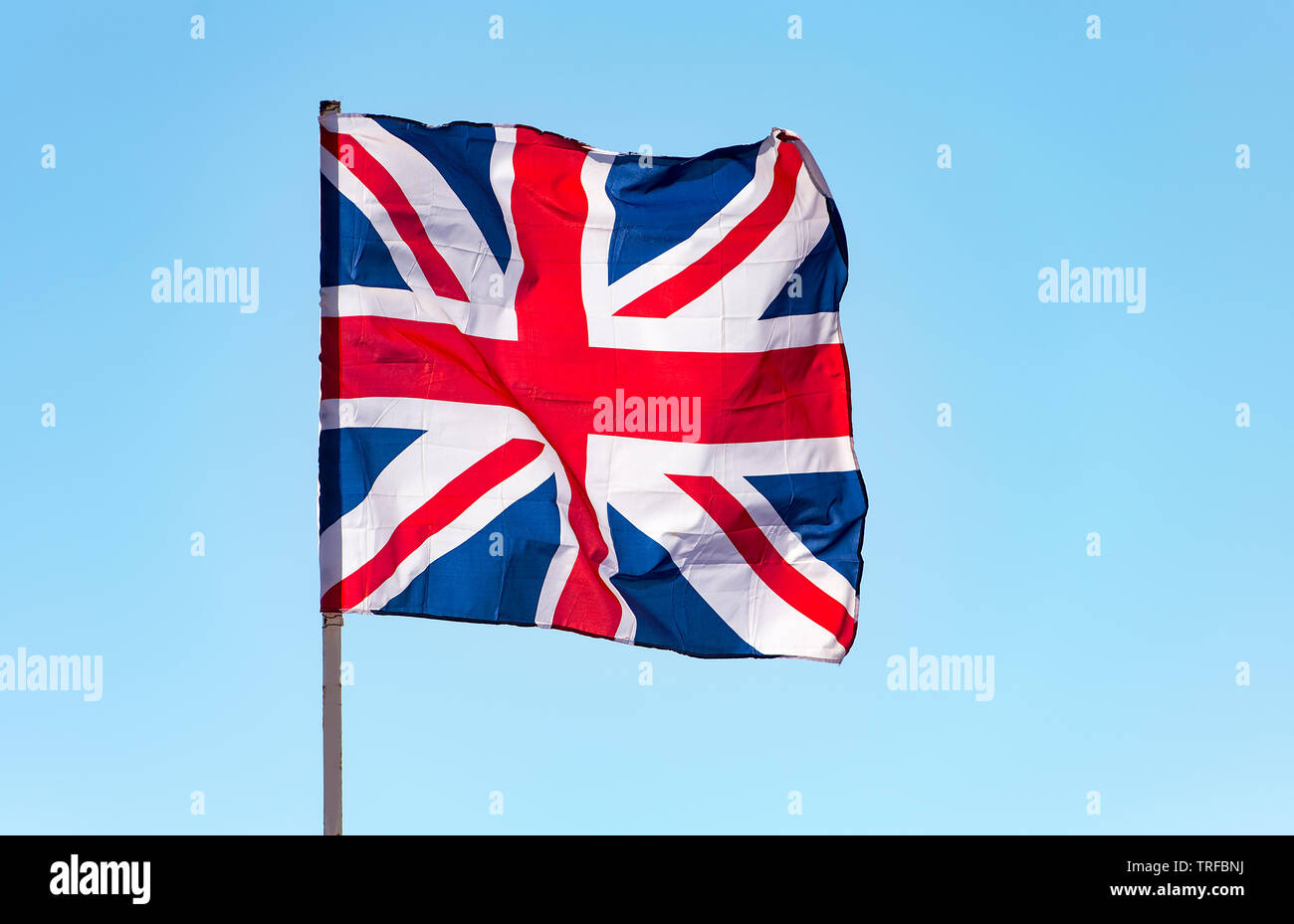 London, Great Britain flag waving against blue sky, the British flag