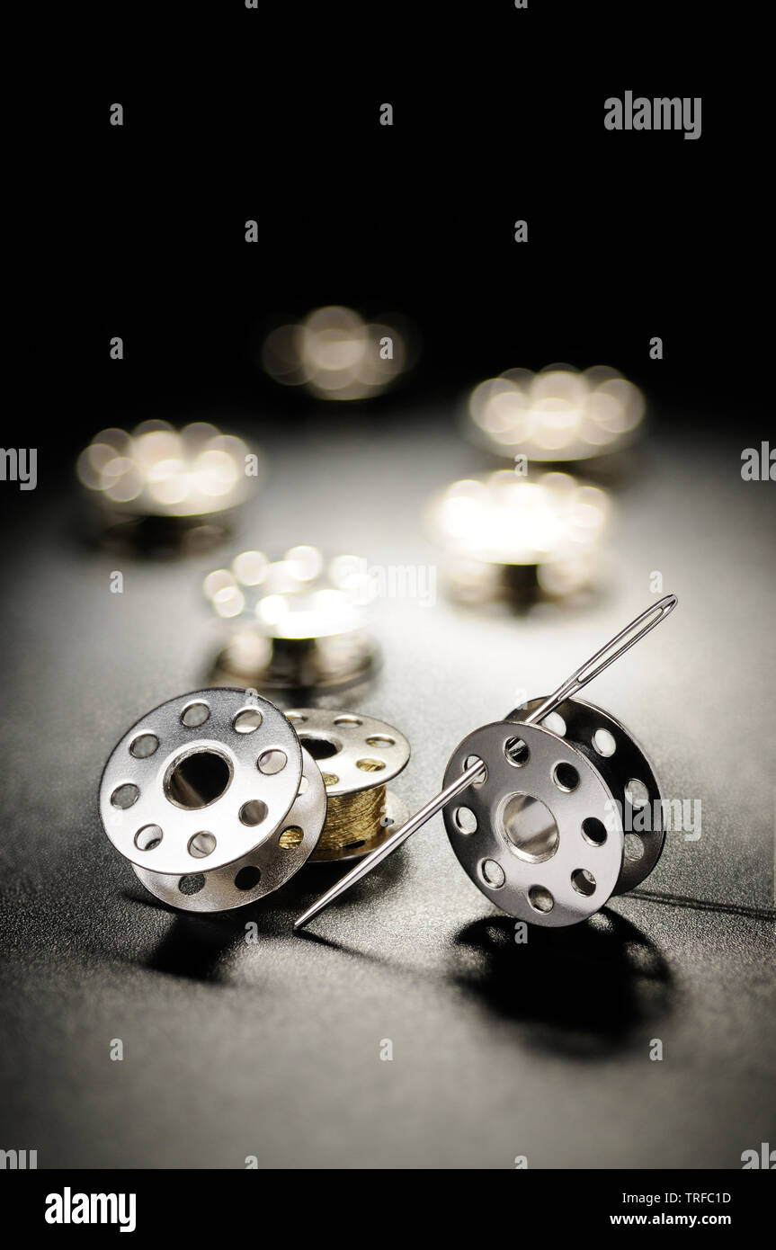Metal spools of sewing machine on a black background Stock Photo Alamy