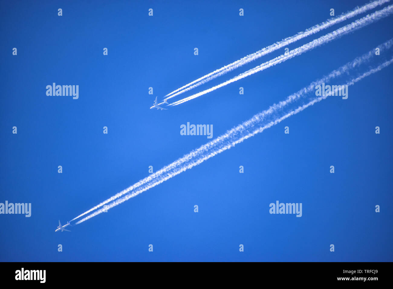 Contrails, Condensation Trails, two planes, aircraft, dogfight, on collision course Stock Photo