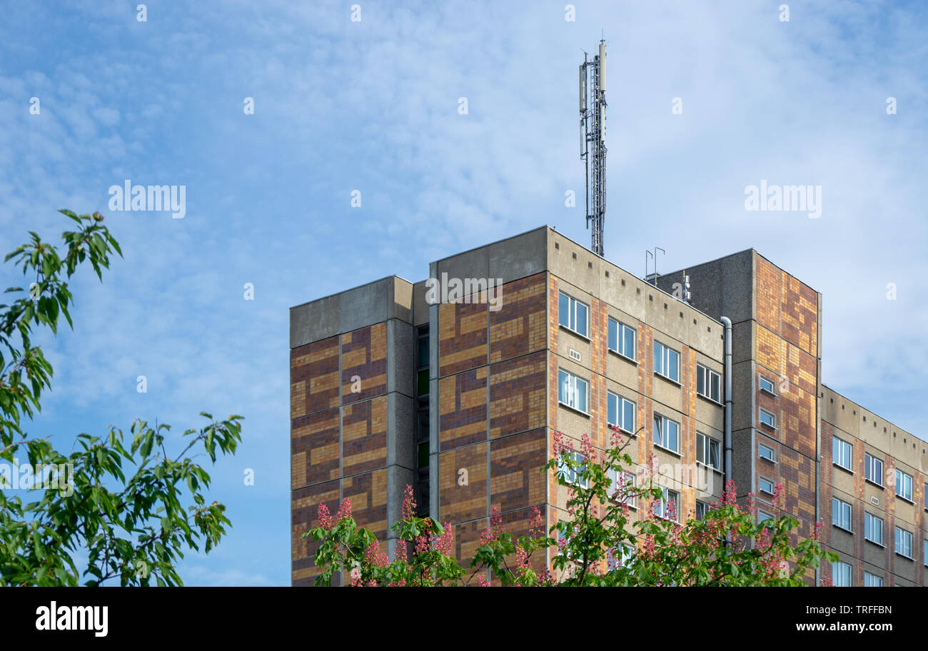 modern or old apartment building - skyscraper with mobile radio antenna on the roof Stock Photo