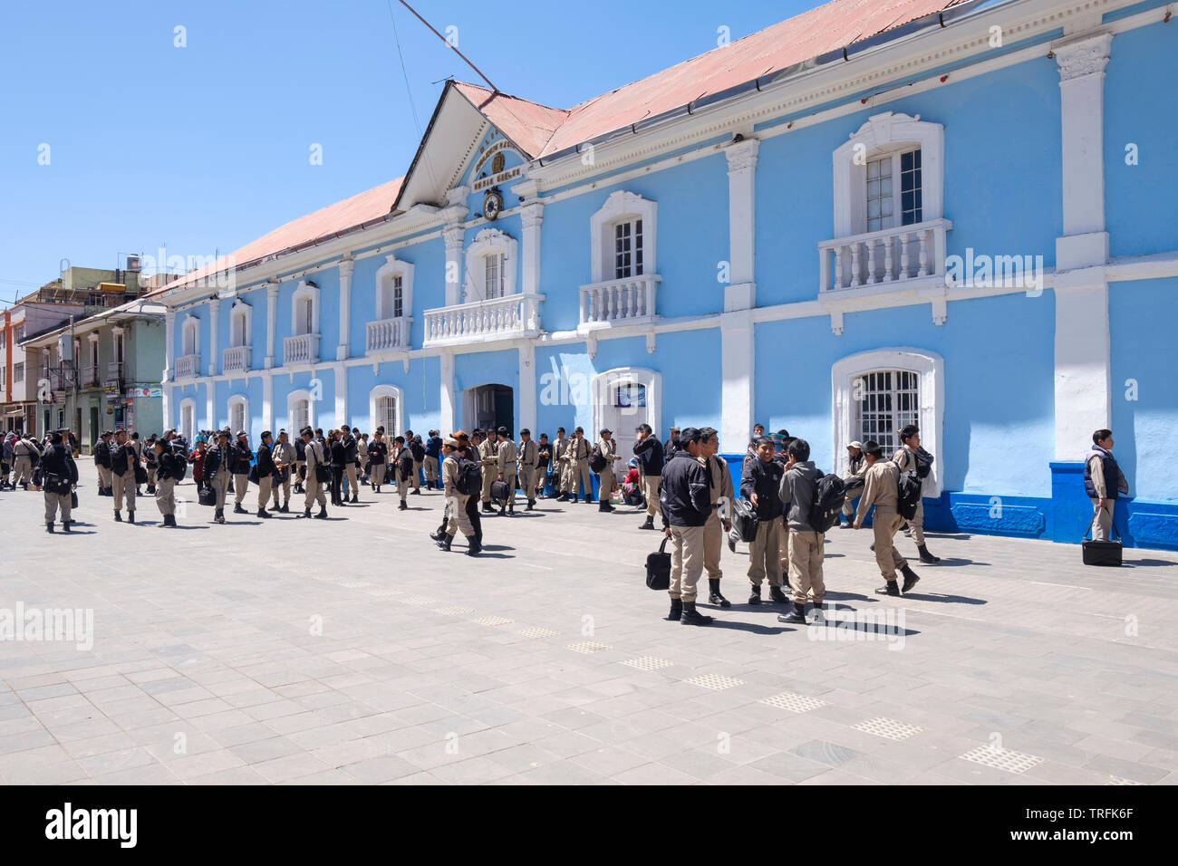 Groups of students in school uniform meeting outside the Colegio Nacional de San Carlos or San Carlos School after class in Pino Park, Puno, Peru Stock Photo