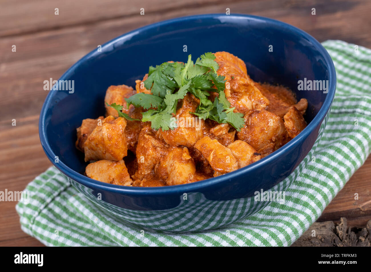 delicious indian butter chicken curry dish with cilantro on top Stock Photo Alamy