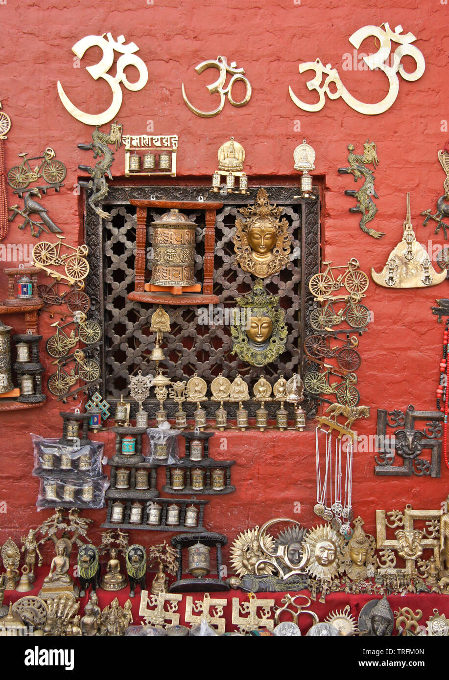 Buddhist and Hindu masks, prayer wheels, and other religious and souvenir items displayed for sale at Swayambhunath  Buddhist temple, Kathmandu, Nepal Stock Photo