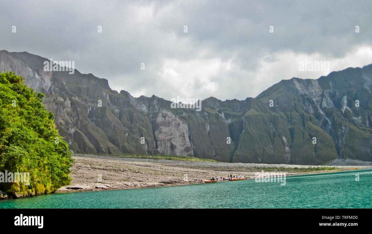 The shoreline of the lake to view the deepest lake in the Philippines at eyelevel, one is engulfed in the grand crater of the volcano. Stock Photo