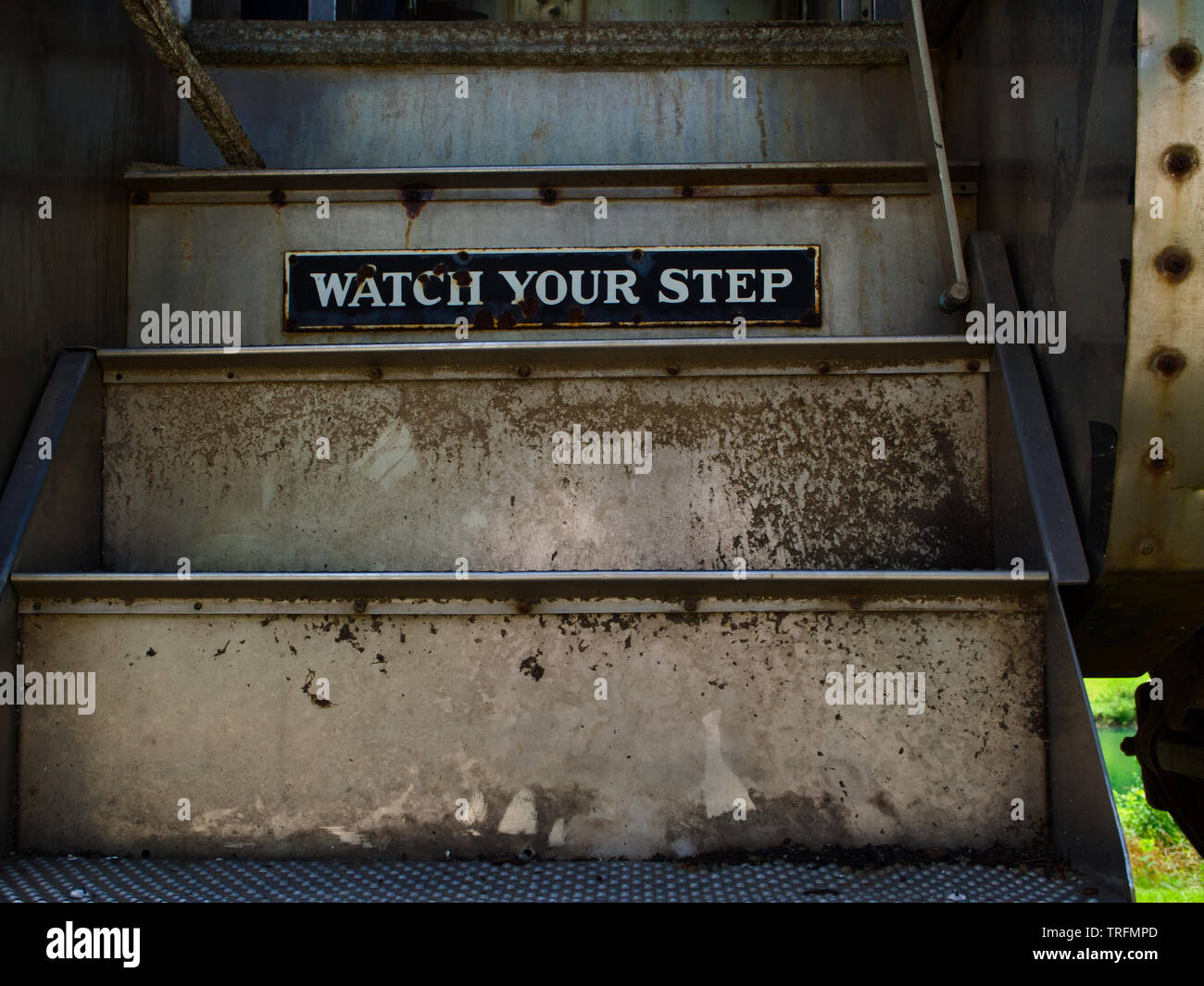 rail road passenger car steps with ' watch your step' sign Stock Photo