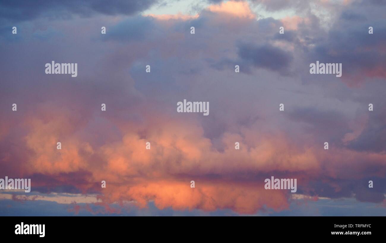 Sunlight shining through the Pink puffy clouds Stock Photo