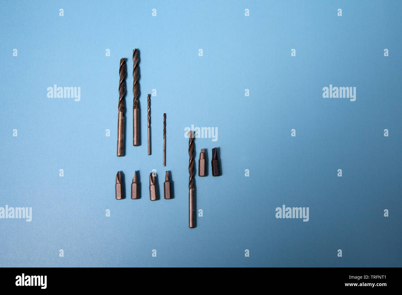 Drill heads and bits on a lay flat blue background Stock Photo