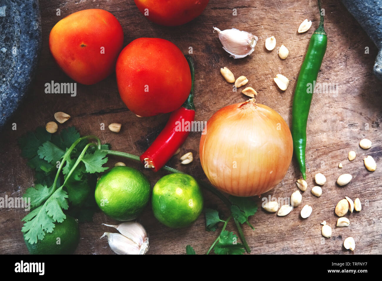 a bunch of fresh vegetables and fruits on a cutting board Stock Photo