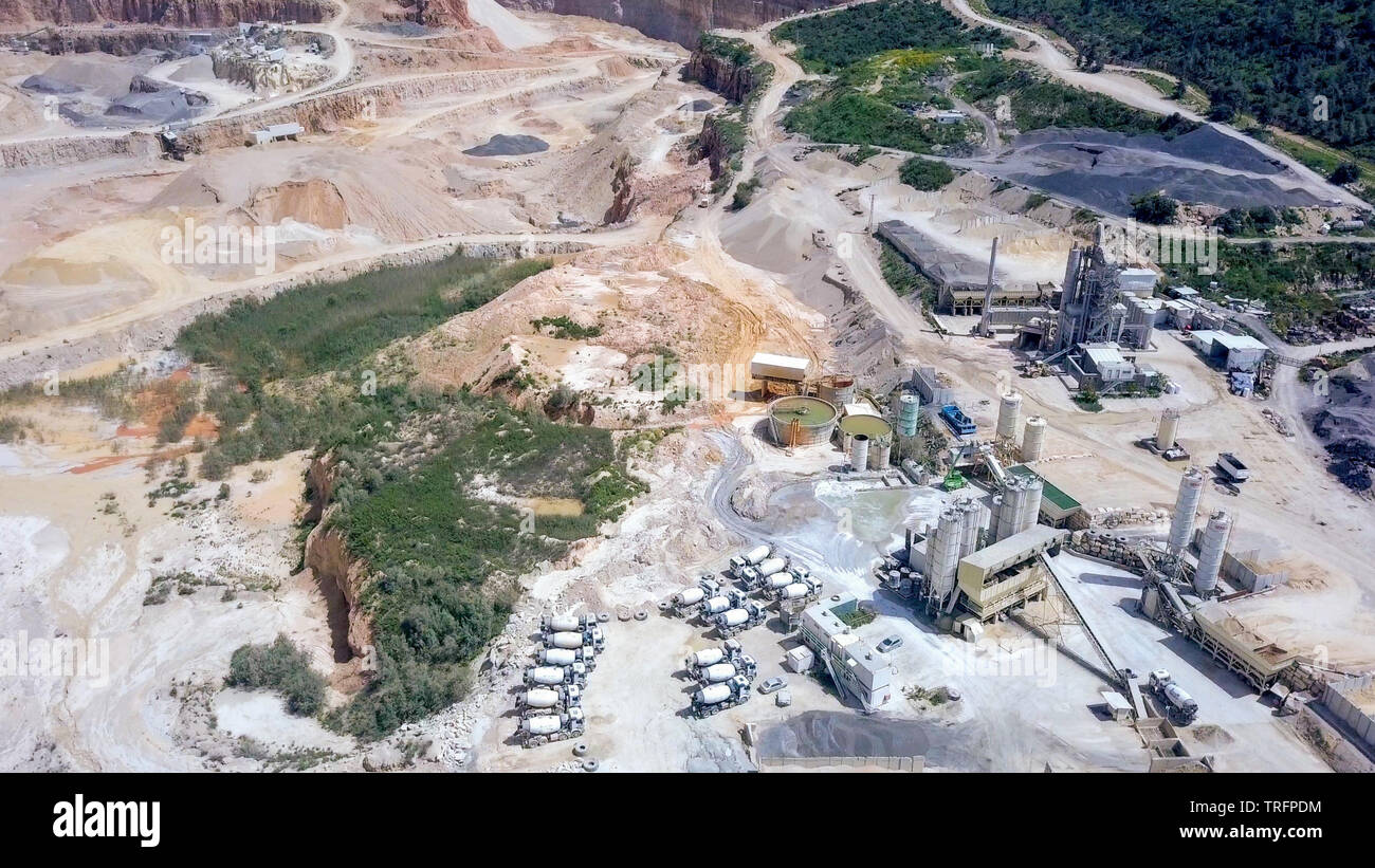 Large Quarry during work hours with Stone sorting conveyor belts - Aerial tour. Stock Photo
