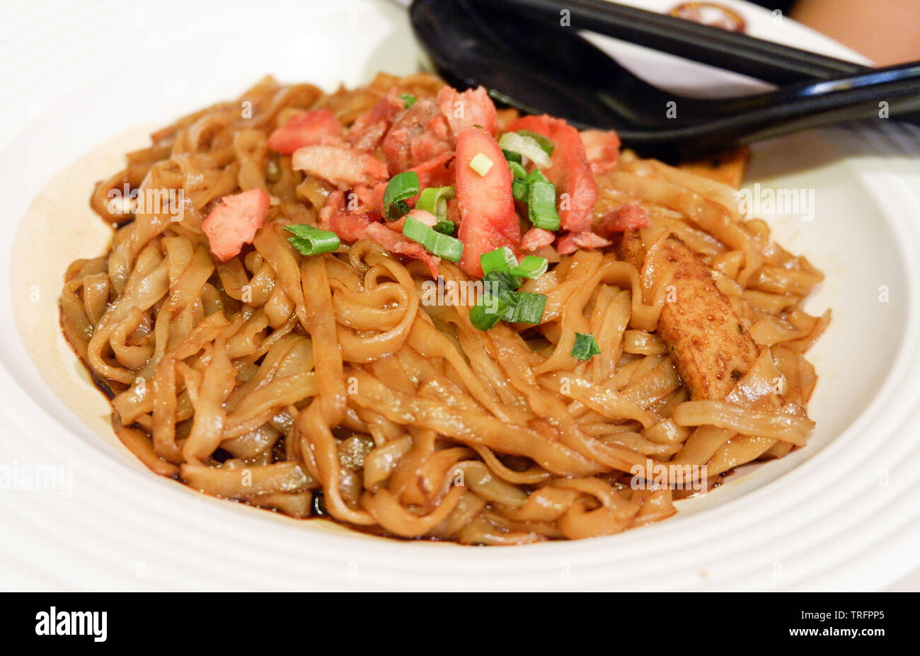 Noodle Fried soy sauce with roasted red pork on plate / Malaysian food Stock Photo Alamy