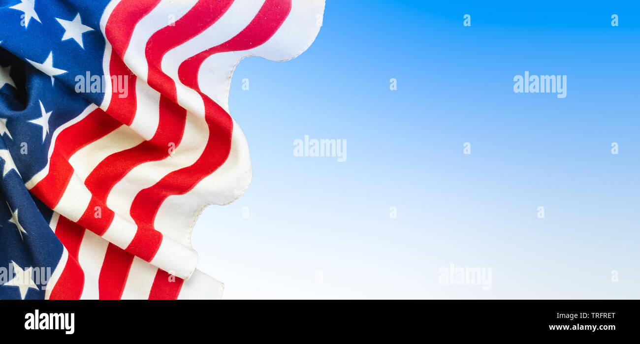 USA flag background. Close-up of American flag on the left side, blue and white colored space for text on the right side of the image. Stock Photo