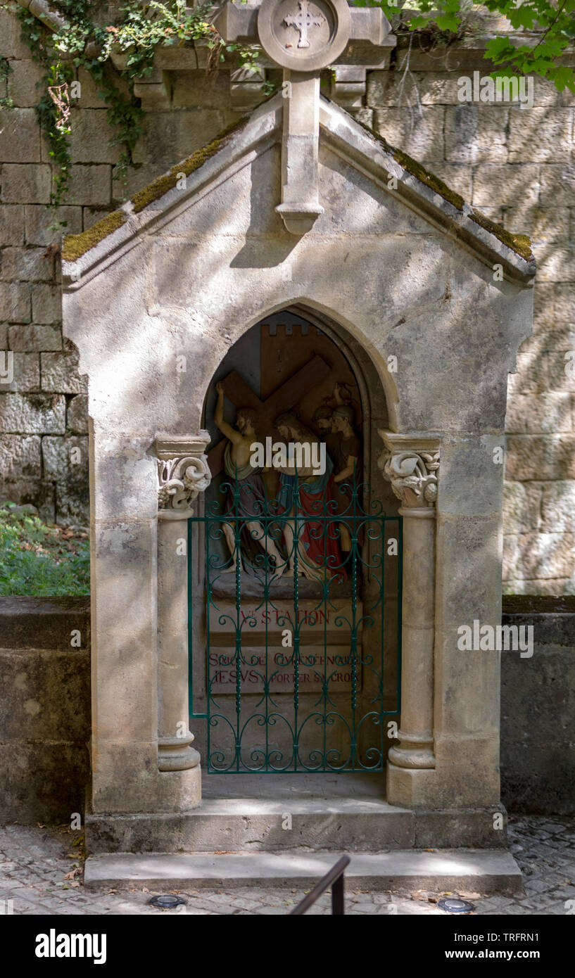 Rocamadour, France - September 3, 2018: Statinon 5 Simon of Cyrene helps carry the cross. Stations of the Crucifixion Way at the sanctuary of Rocamado Stock Photo