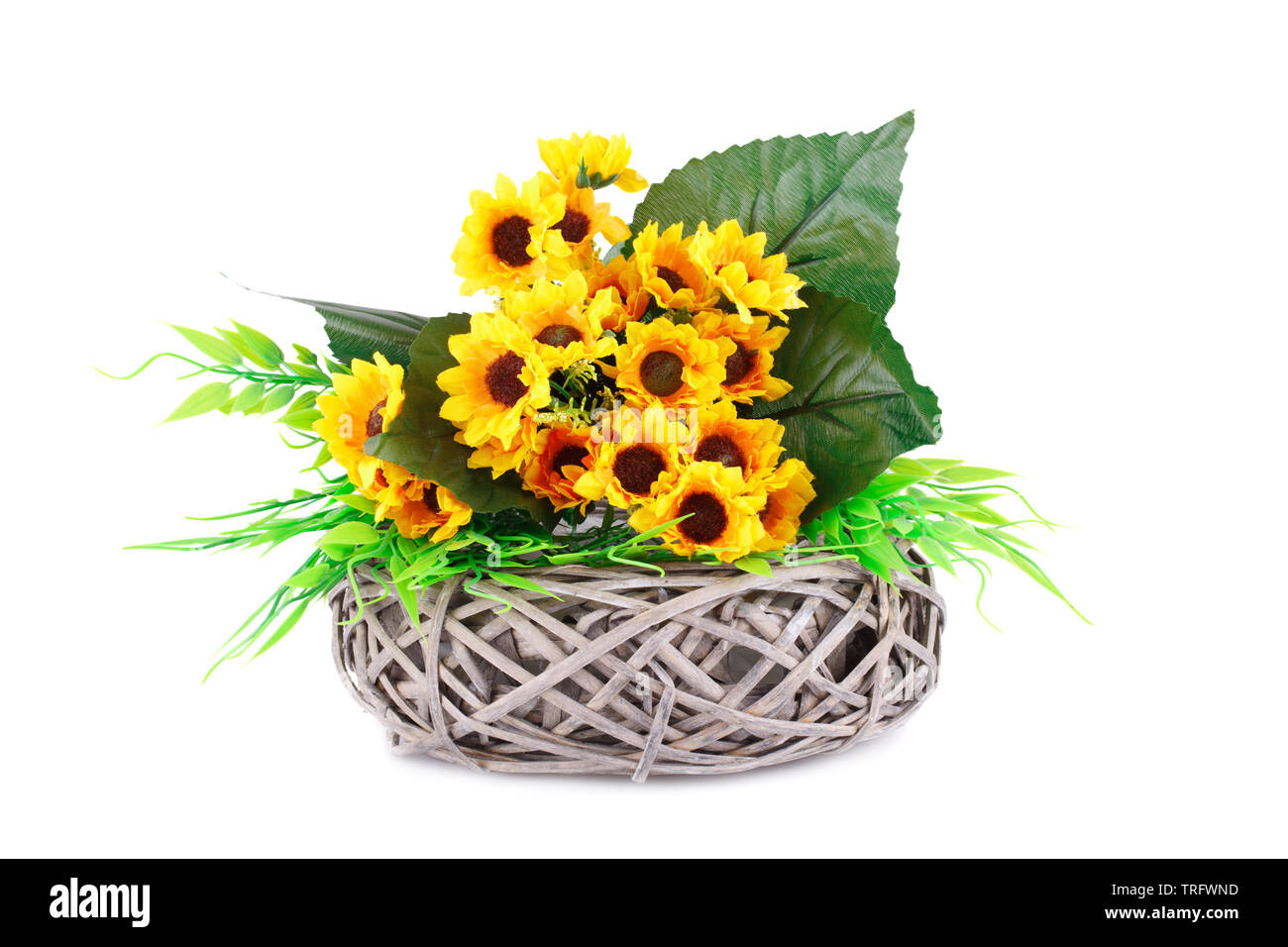 Yellow fabric flowers in wicker basket isolated on white background ...