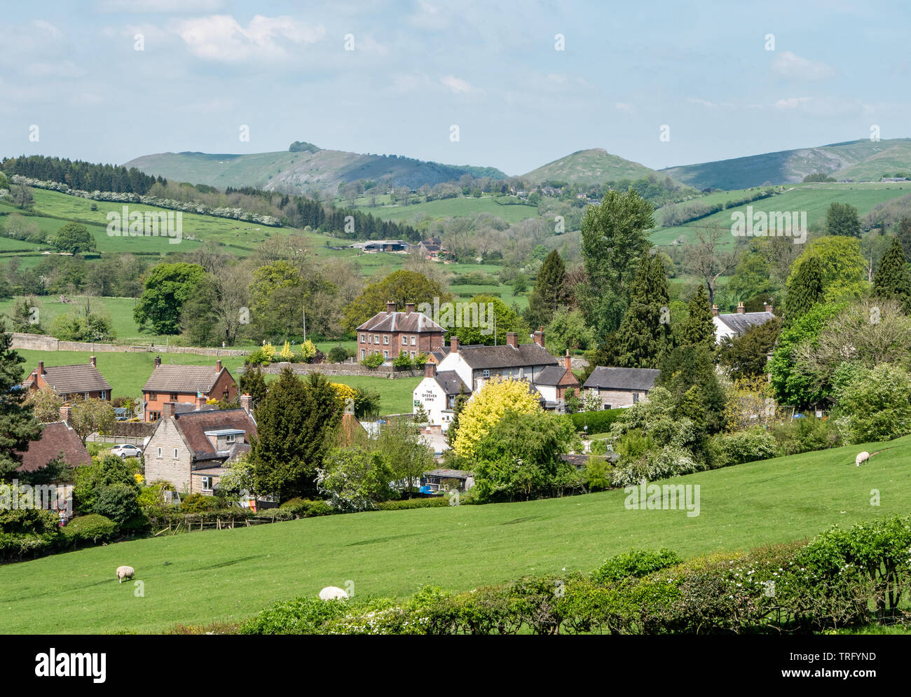 The village of Mapleton in the Dove valley Derbyshire UK with Thorpe Cloud and Bunster Hill bordering Dovedale on the horizon Stock Photo