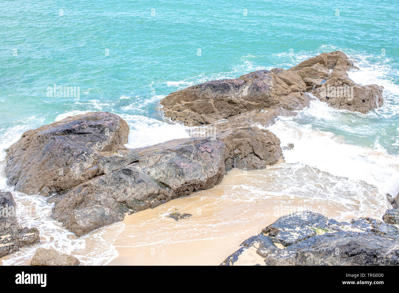Images of rocks with waves crashing on a beach at St Ives in Cornwall UK Stock Photo