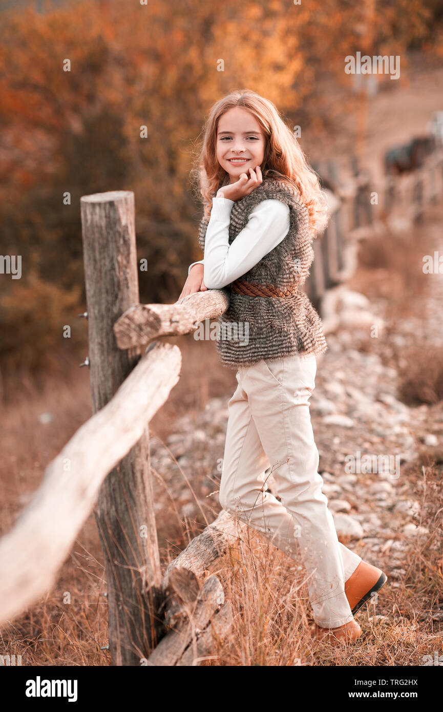 Beautiful teen girl 14-16 year old wearing stylish autumn clothes in park.  Looking at camera Stock Photo - Alamy