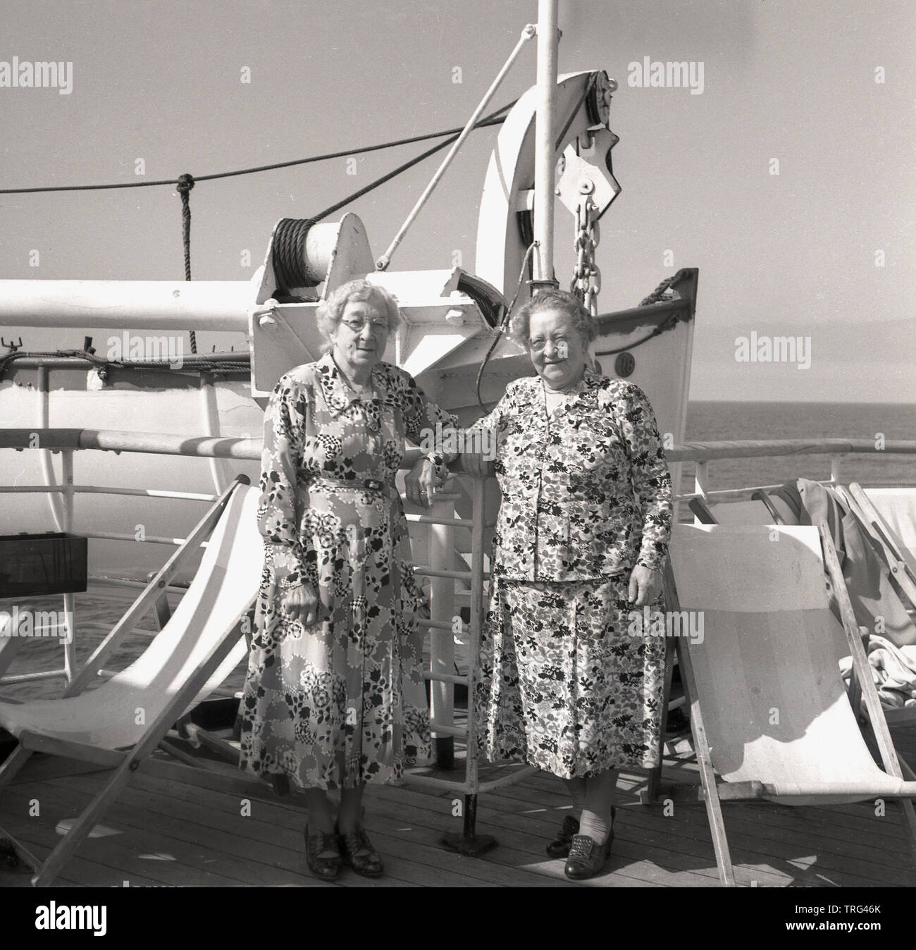 1950s Historical Cruising On An Ocean Liner In This Era Two Elderly Ladies Wearing Flower Patterned Dresses Standing Outside On The Deck Of The P O Chusan Cruise Ship Stock Photo
