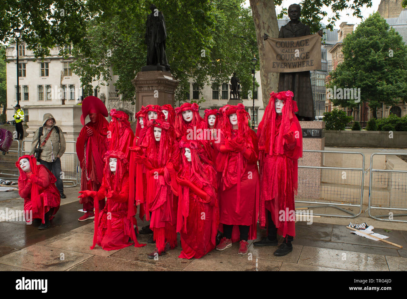 4 June 2019 - Parliament Square, London, UK - Invisible Circus (Red Brigade) in Parliament Square during a protest against US president Donald Trump's state visit to the UK. Bristolian Doug Francisco, founder of The Invisible Circus launched as a street performance troupe in the 90s. Stock Photo